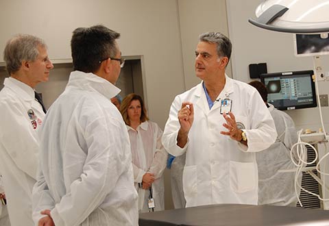 Dr. Kamal Itani, Chief of Surgical Service, VA Boston Healthcare System, right, demonstrates the use and functionality of VA Boston’s new Hybrid Operating Room to Vincent Ng, Director of VA Boston Healthcare System, left, and Dr. Michael Charness, Chief of Staff.