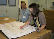 Two staff members reviewing a floor plan