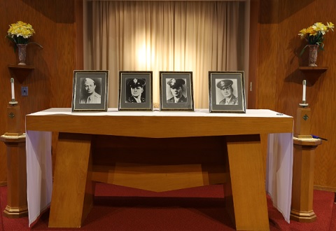 Portraits of the Four Chaplains at the altar at the VA chapel in Leeds, Mass.