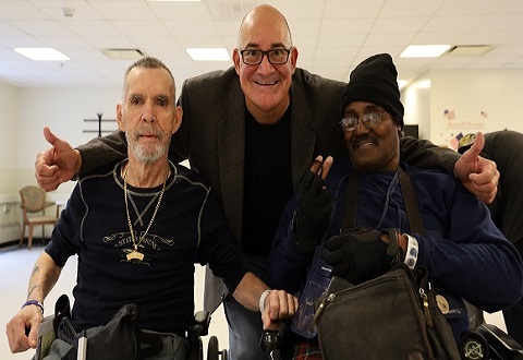 Entertainer Wayne Soares, center, with Vietnam Veterans during a visit to VA Bedford